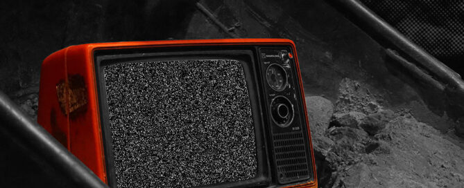 Red televsion with static snow sitting on a black and white background